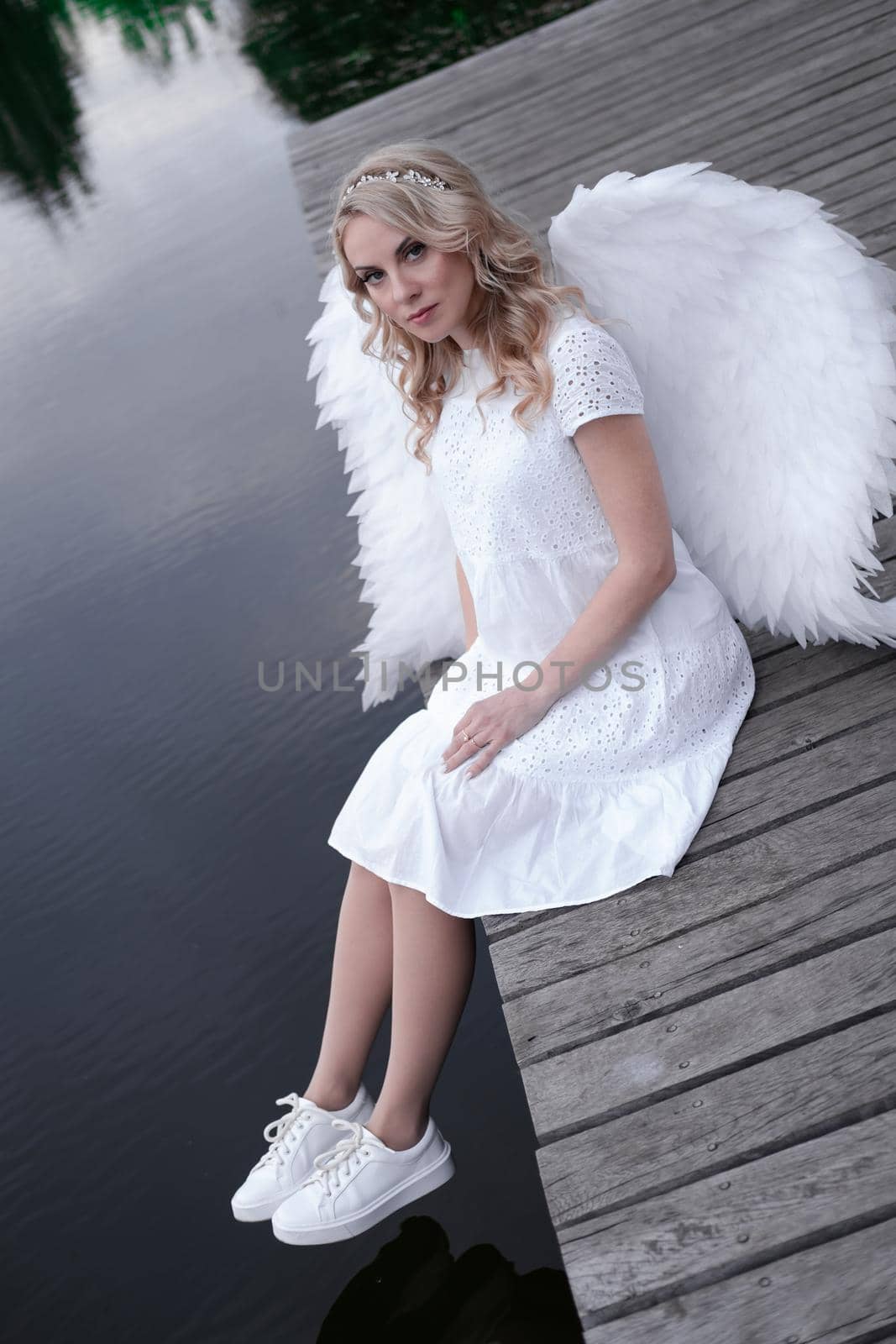 beautiful angel in white dress. Amazing blond woman with long curly hair and white wings. by oliavesna