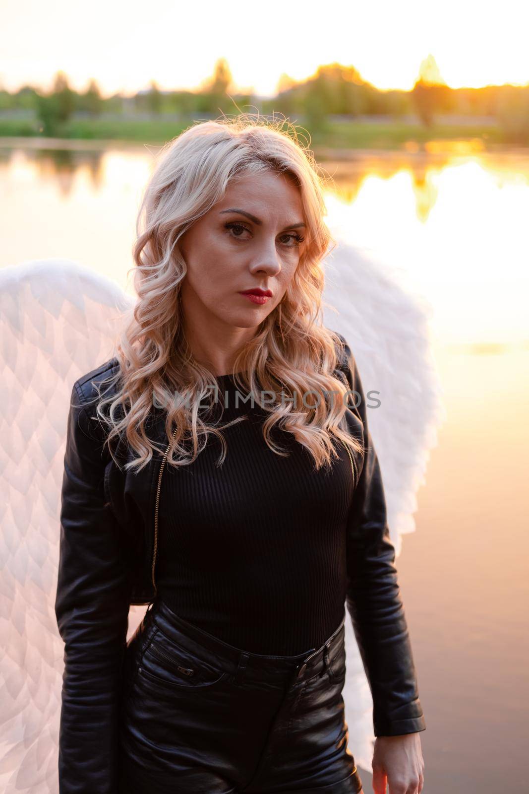 fallen angel. girl in black with white angel wings