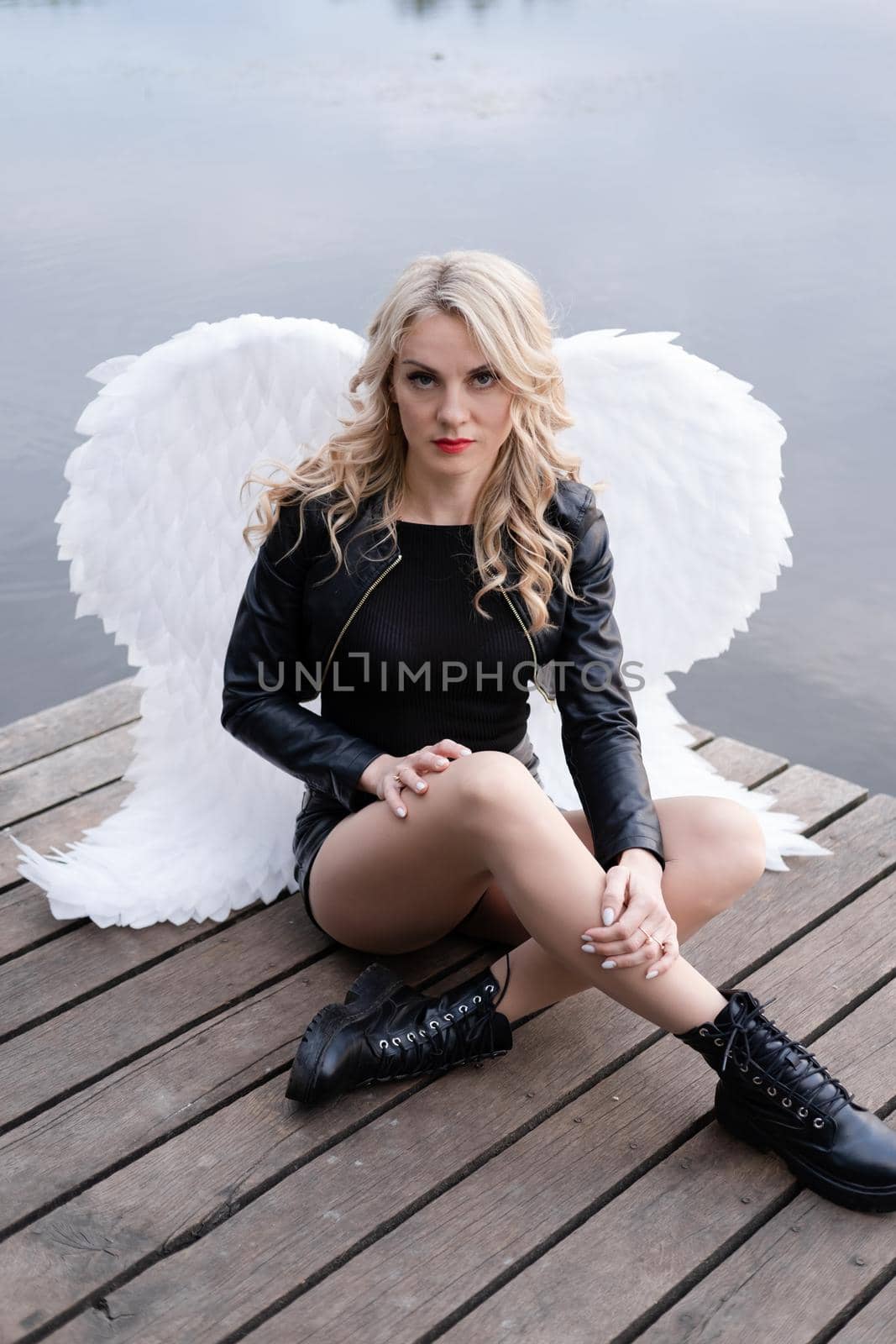 portrait of a sensitive woman with white angel wings. wearing black leather clothes. fallen dark angel. demon. beast. by oliavesna