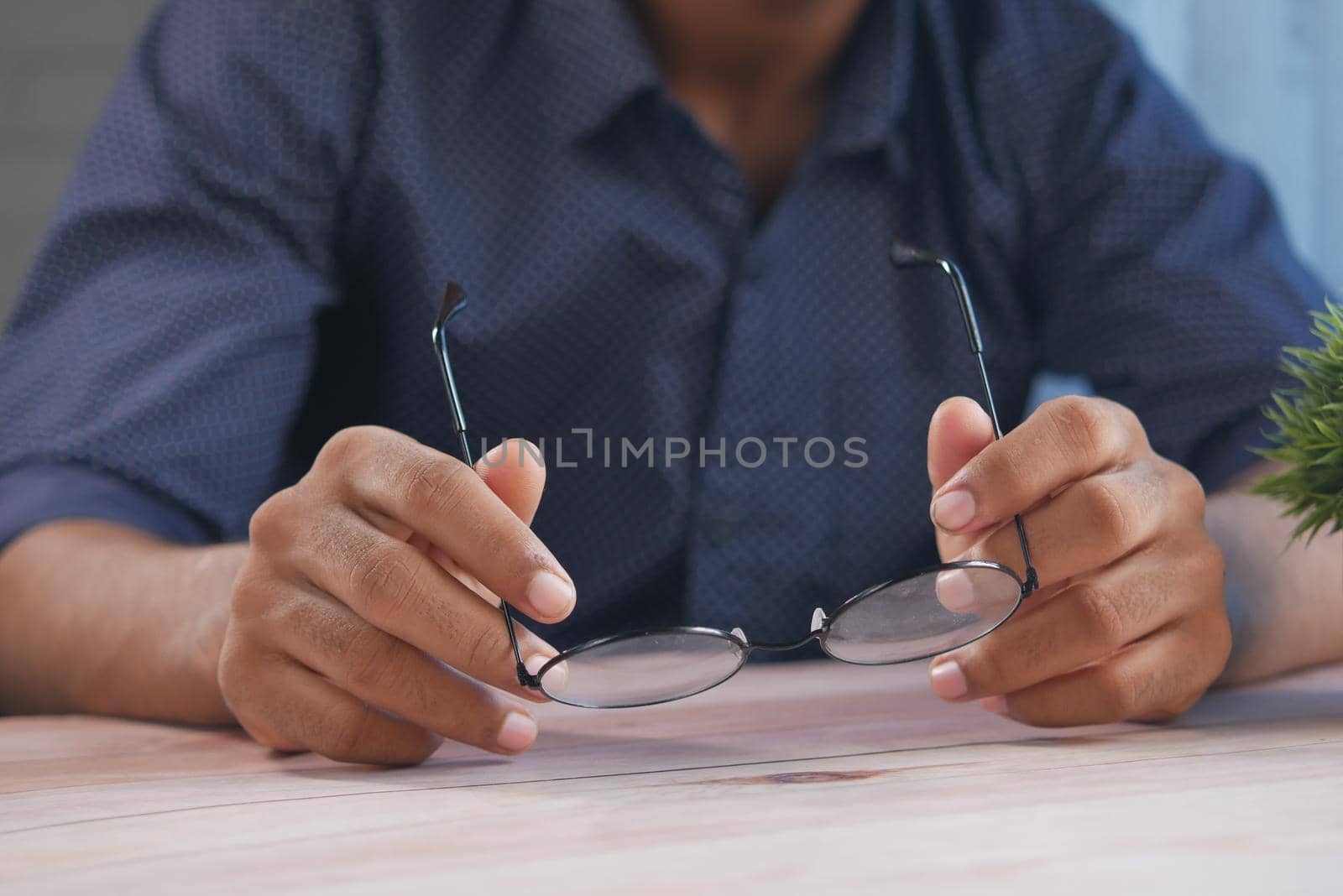 Close up of man hand holding eyeglass,