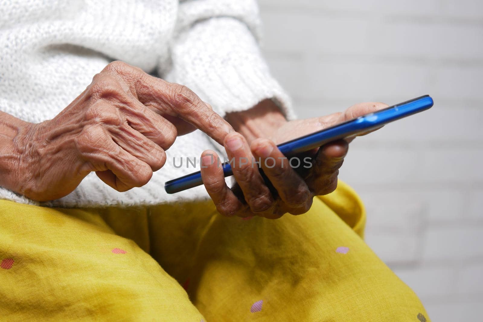 senior women hand using smart phone close up .