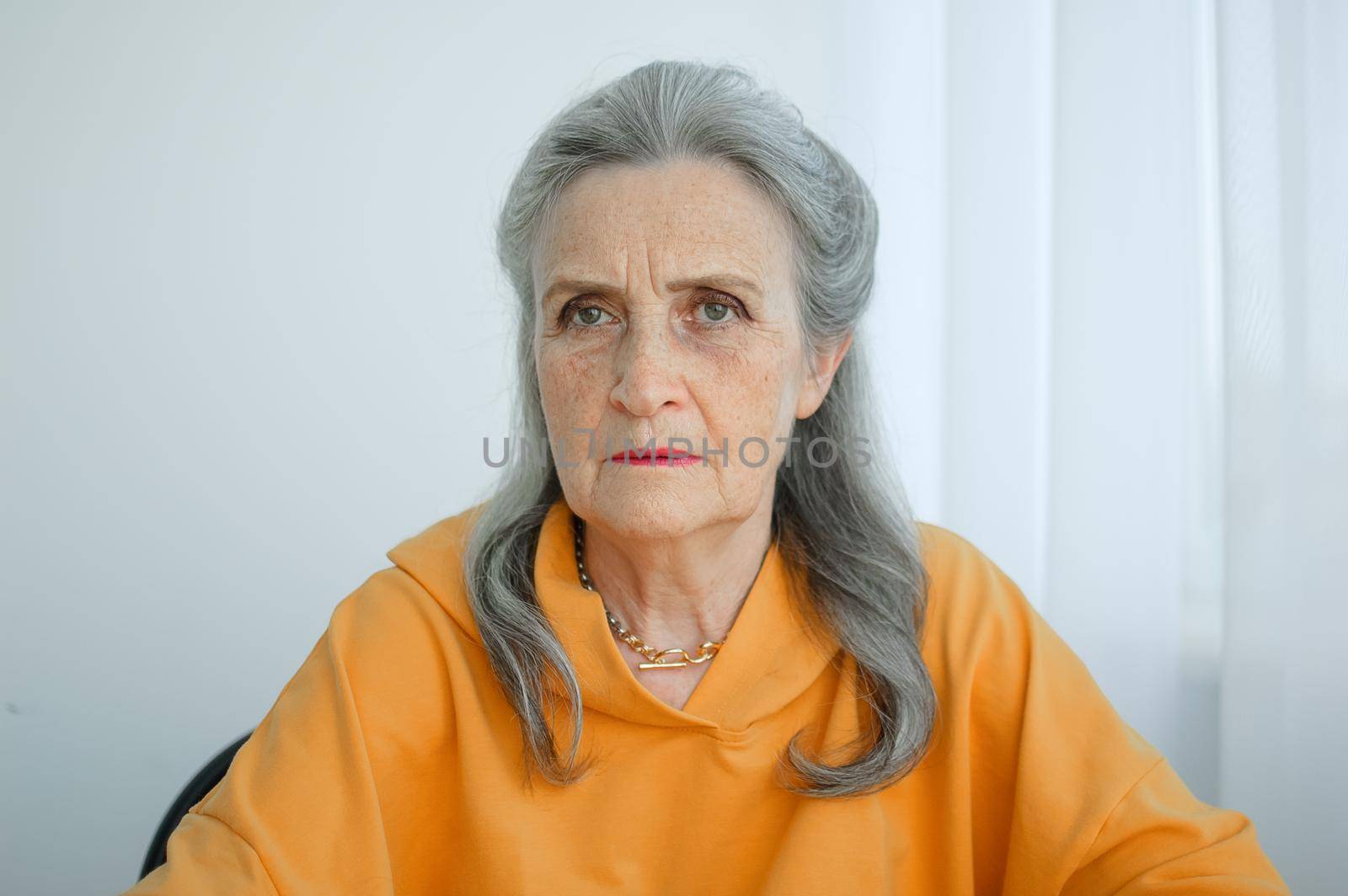 Closeup portrait of angry upset senior mature woman talking with someone and looking at the camera. Negative emotion, facial expression, scandal.