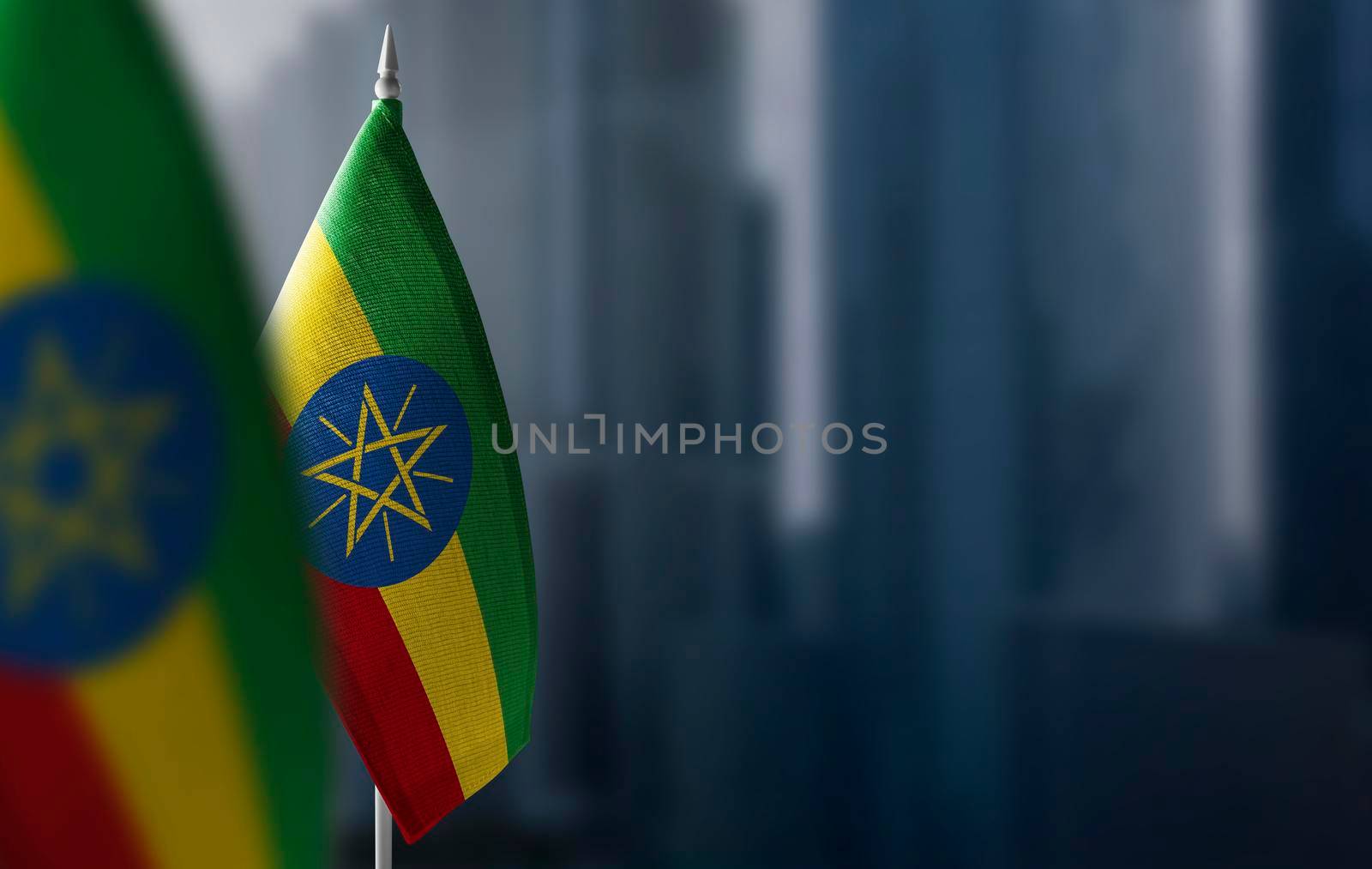 Small flags of Ethiopia on a blurry background of the city.