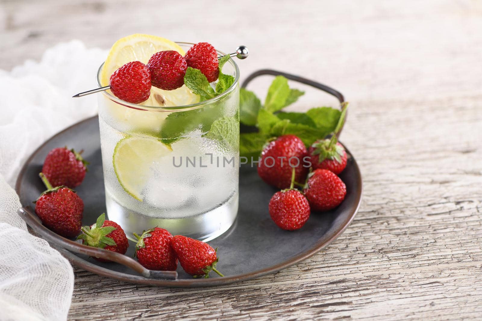 Refreshing organic Mojito cocktail with fresh lime, white rum combined with fresh strawberry and mint. This is the perfect cocktail for summer days.
