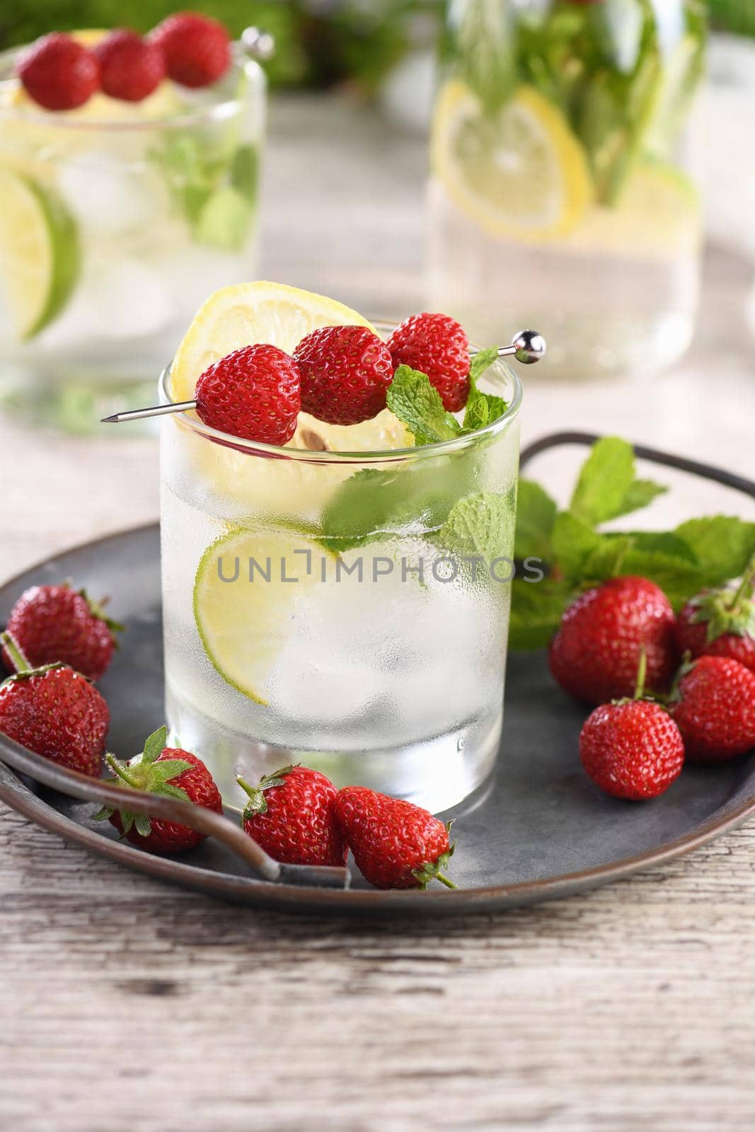 Refreshing organic Mojito cocktail with fresh lime, white rum combined with fresh strawberry and mint. This is the perfect cocktail for summer days.