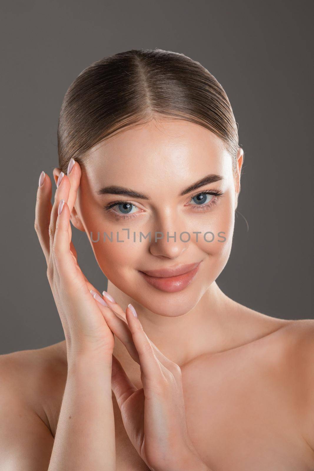 Beauty Portrait. Beautiful Spa Woman Touching her Face. Perfect Fresh Skin. Pure Beauty Model Girl. Youth and Skin Care Concept