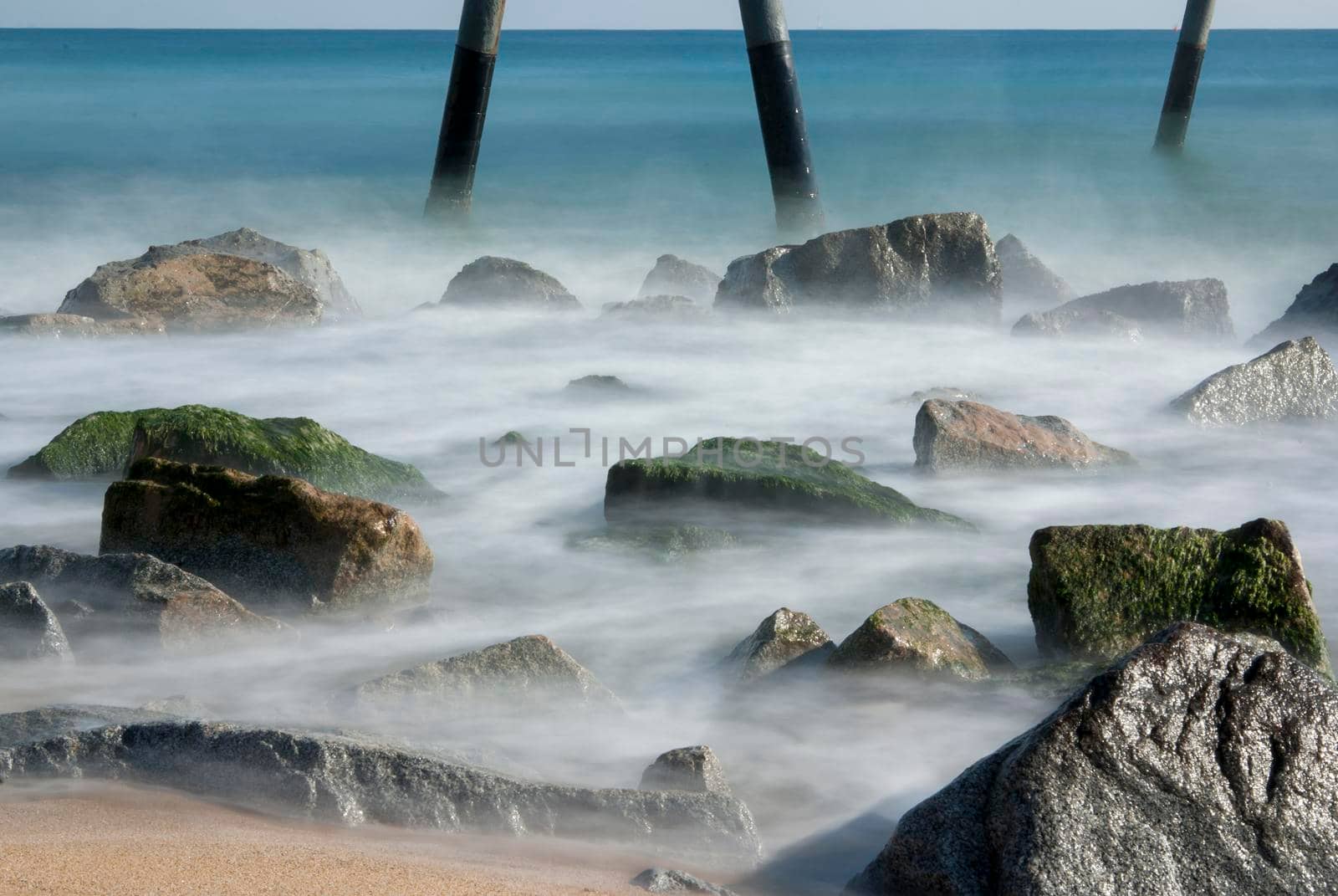 mediterranean sea with view to the pontoon and beach - Pont del Petroli, Badalona, Barcelona, Catalonia, Spain.