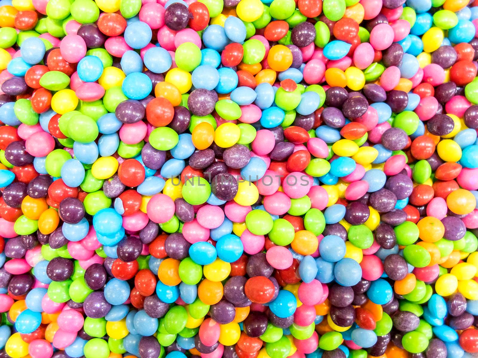 Colorful candies as background, top view