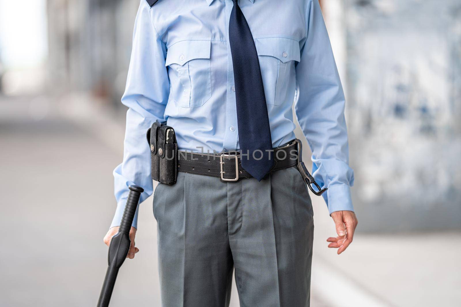 policeman with a baton on a city street.