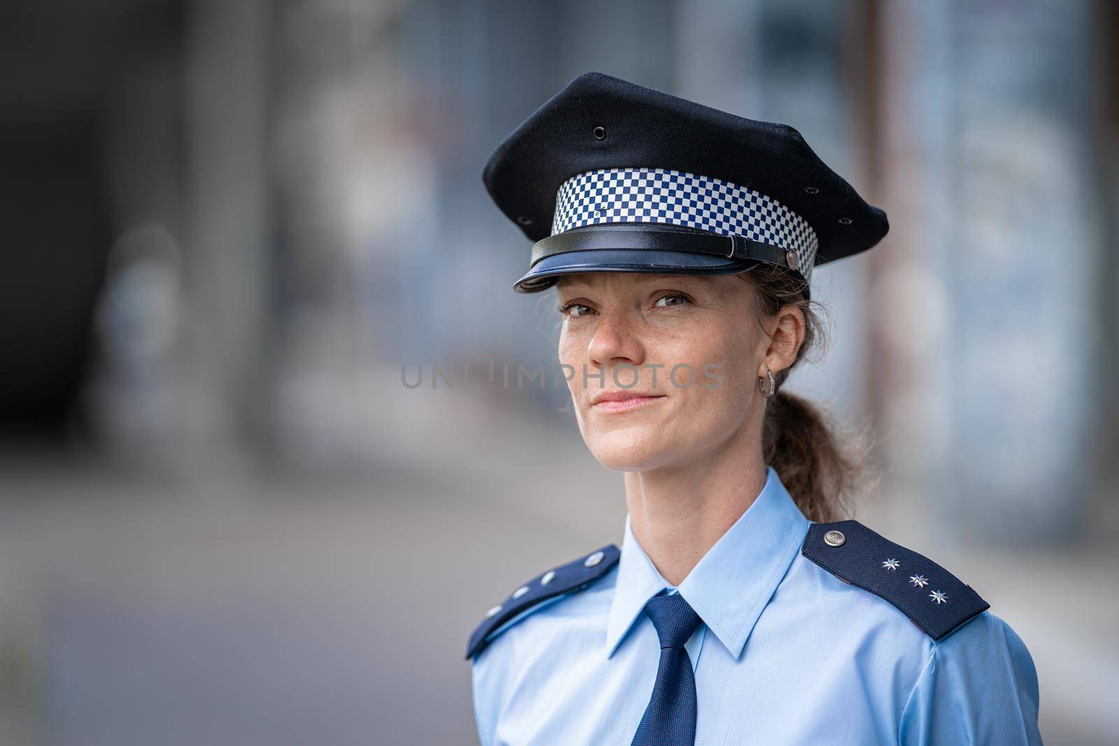 portrait of a young female policewoman in uniform by Edophoto