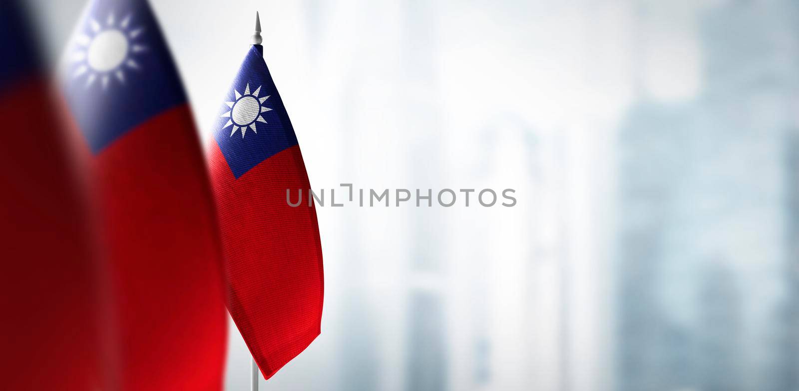 Small flags of Taiwan on a blurry background of the city.
