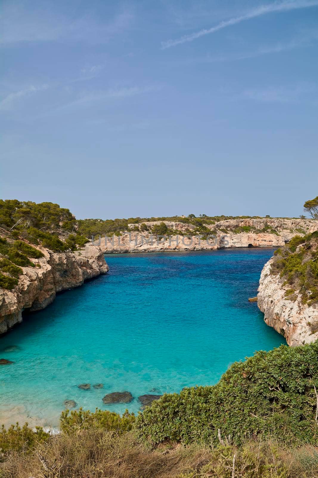 Paradise beach of the mediterranean sea, turquoise water, yes people, cliffs, rocks, white sand, Balearic Islands, Spain