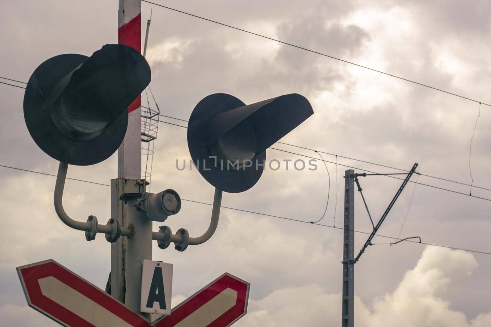 Traffic light at a railway crossing. The object of increased attention is at the intersection of the road and railways.