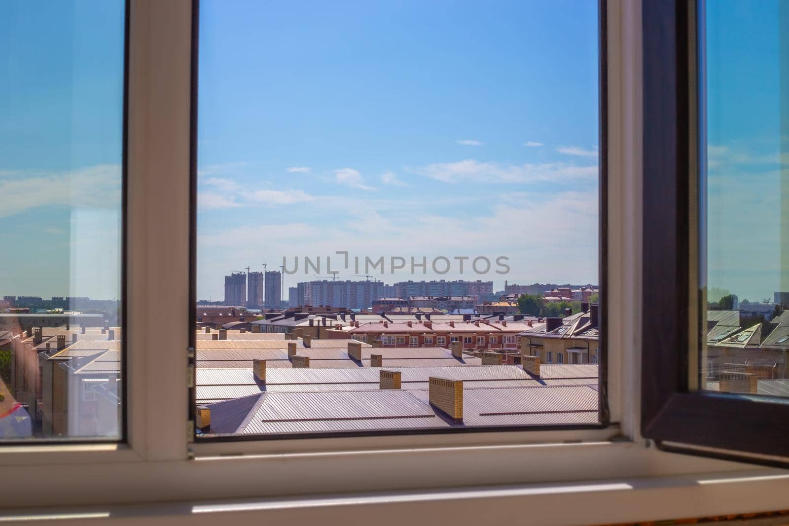 View from the window of a multi-storey building to a new village of brick houses. Construction and real estate by levnat09