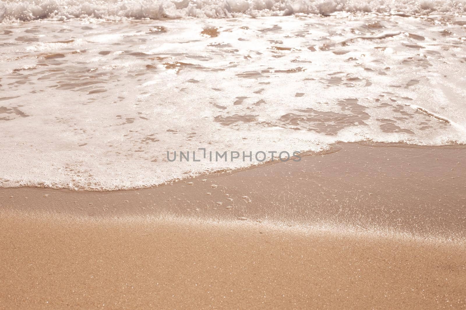 Sea sandy shore with an oncoming wave, beige natural background by levnat09