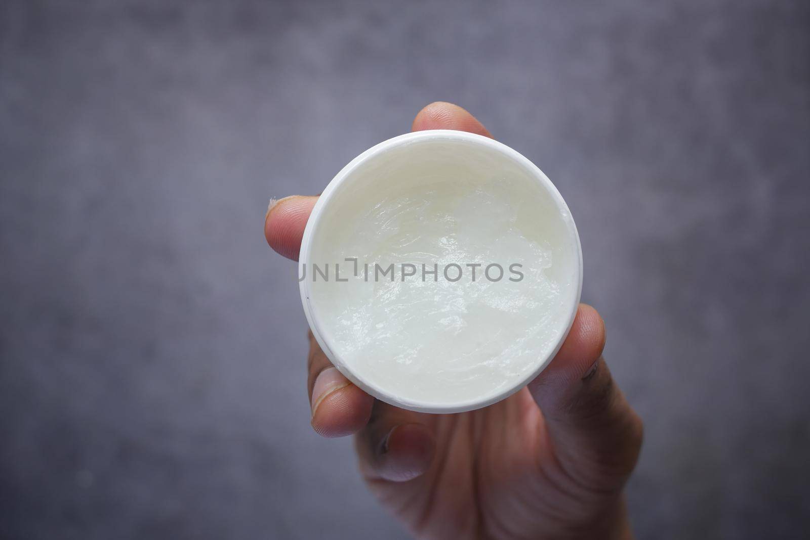 Close up of man hand using petroleum jelly .