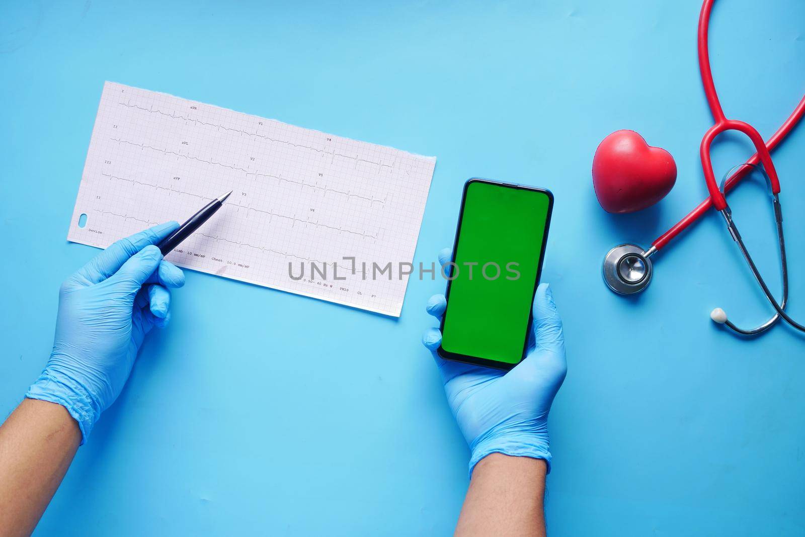 doctor hand in medical gloves analyzing cardio diagram.,