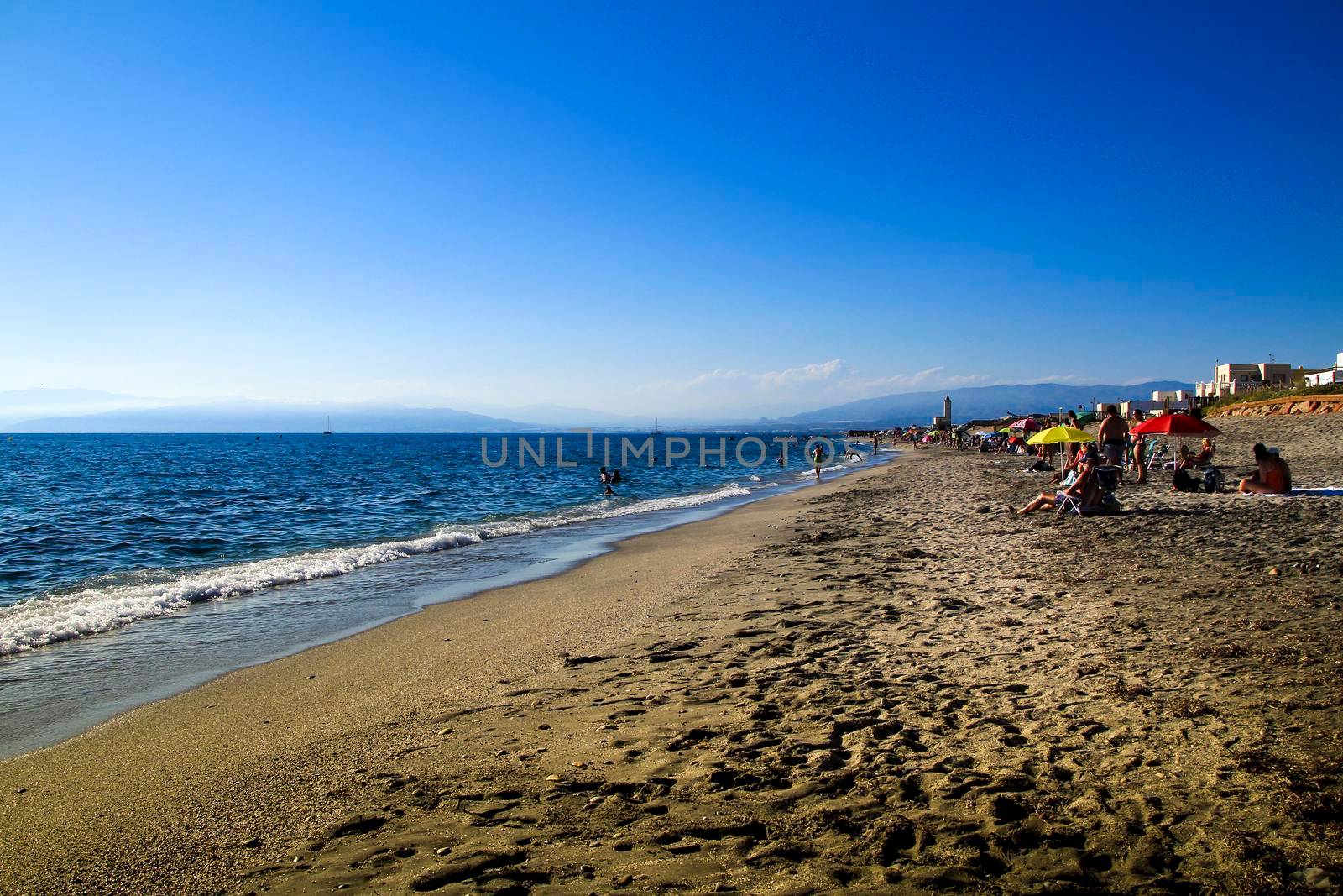 Salinas, Cabo de Gata, Almeria, Spain- September 4, 2021: People enjoying in the Morning on the Salinas beach in Cabo de Gata, Almeria, Spain