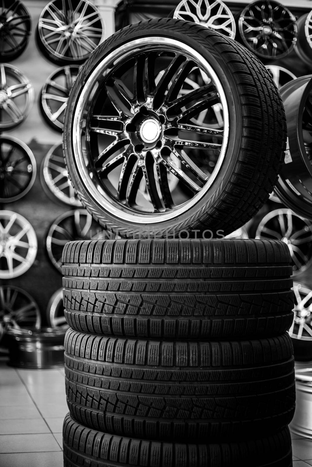A pyramid of rubber tires and alloy wheels. Purchase and sale of new running winter and summer tires by levnat09