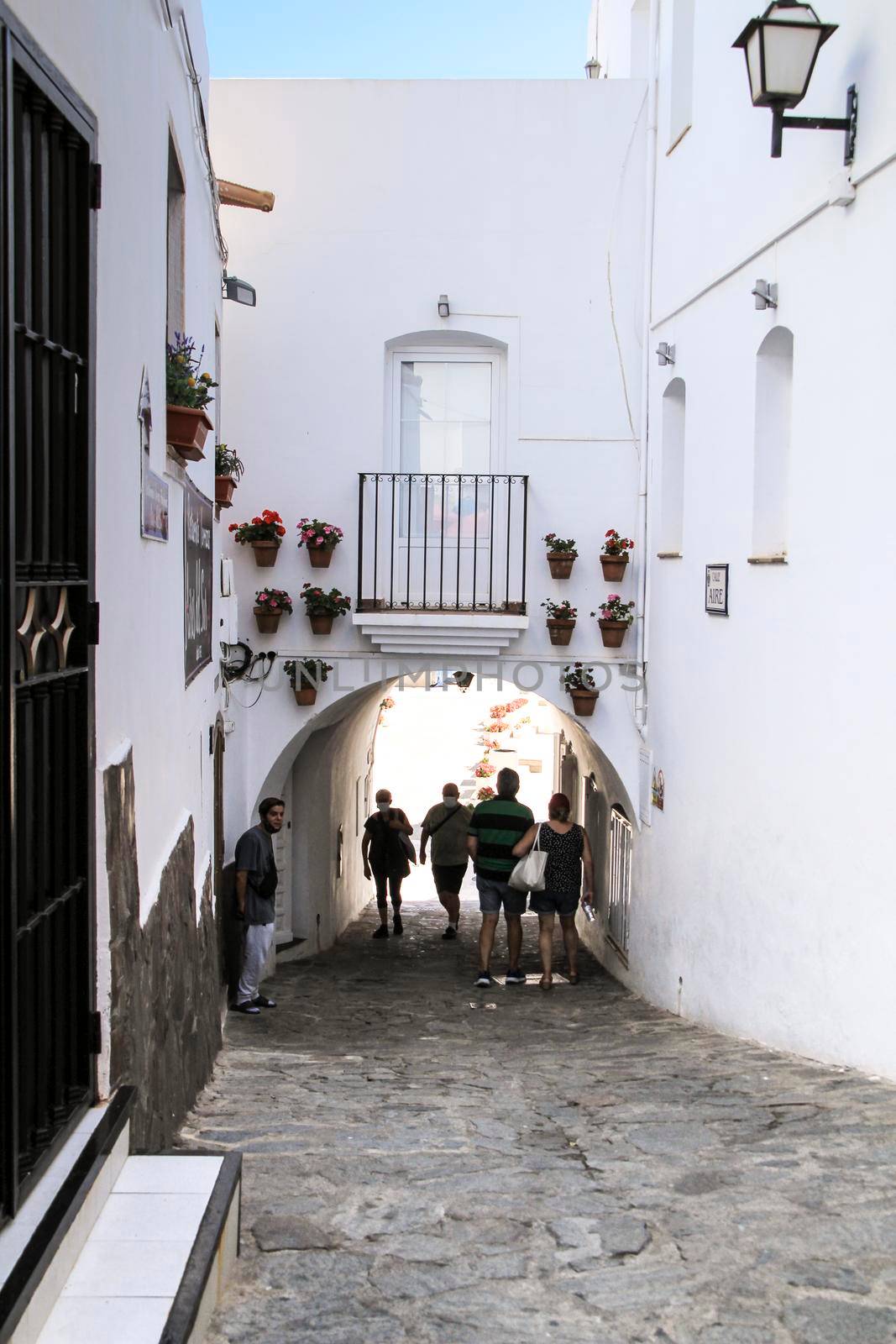 Mojacar, Almeria, Spain- September 8, 2021: Narrow streets with Whitewashed houses in Mojacar village on a sunny day of summer.