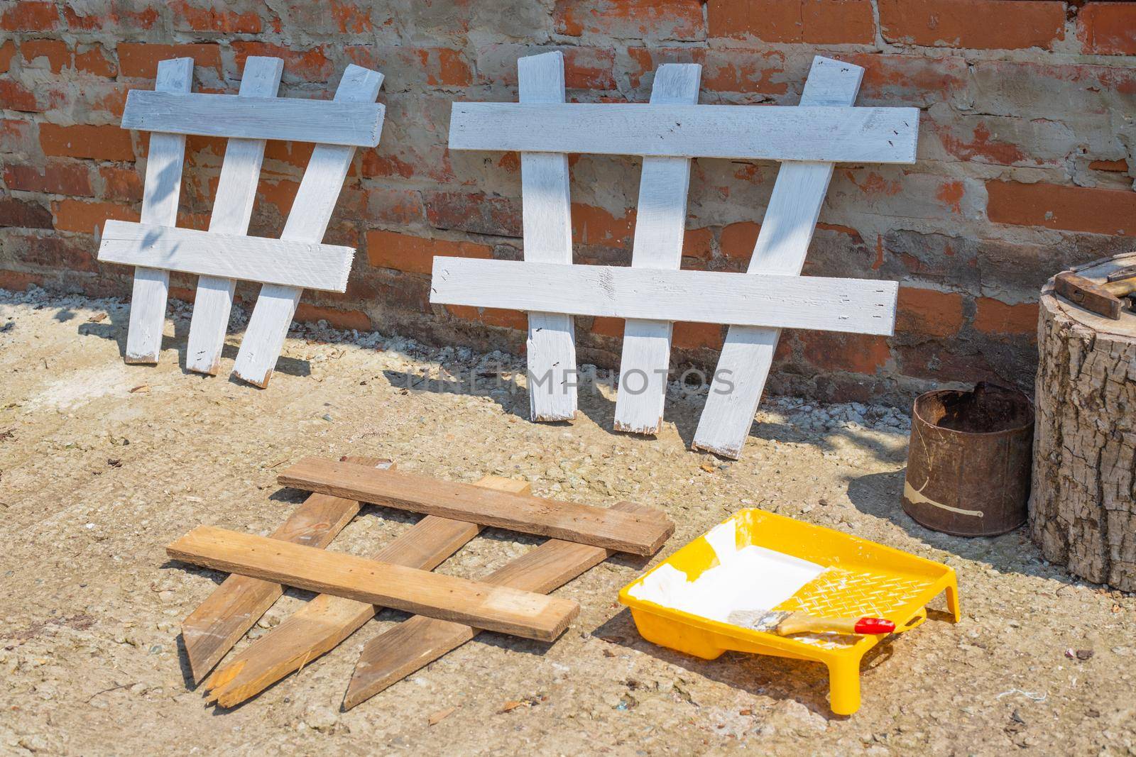 Wooden fence for flowers, making and painting a fence at a summer cottage.
