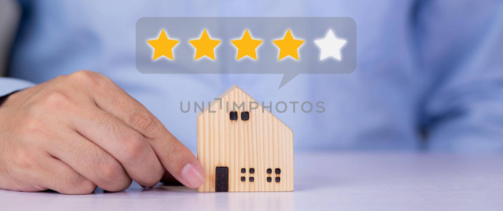 Hands of businessman holding home model with choice for satisfaction and score of guarantee and vote, review and feedback of property, survey and rating, investment of real estate business concepts.