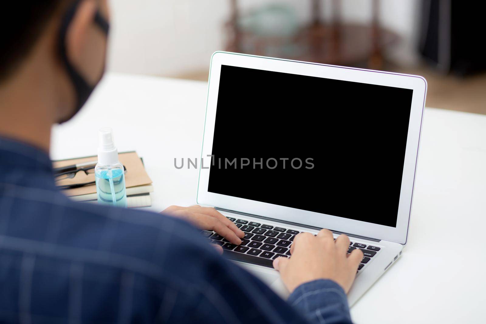 Young asian business man using laptop computer blank screen mockup for video call online and communicate work from home, male conference with notebook, social distancing, communication concept.