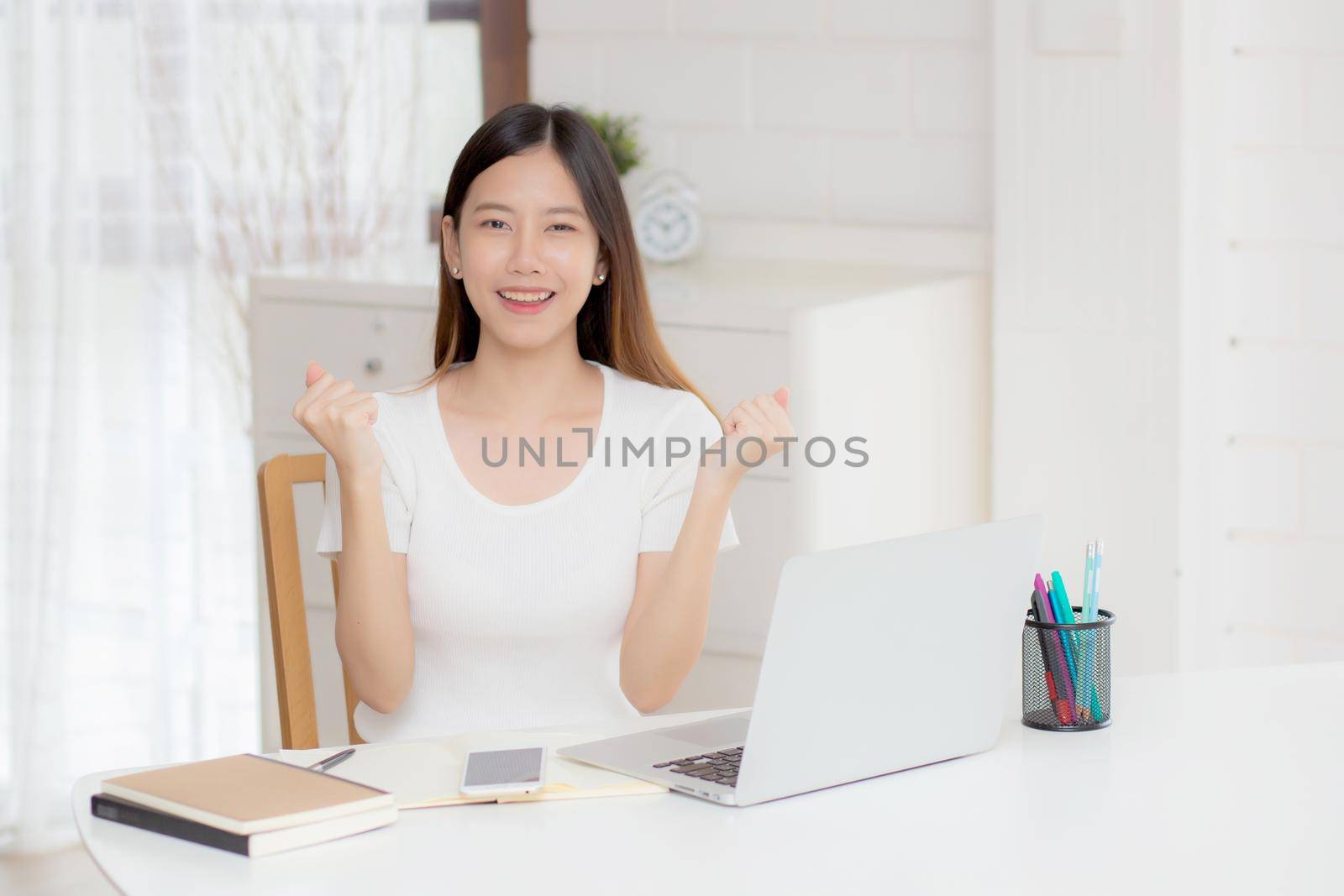 Young asian woman confident working at home with laptop computer and thinking idea for planning, freelance happy girl excited and success using notebook thoughtful and writing, business concept. by nnudoo