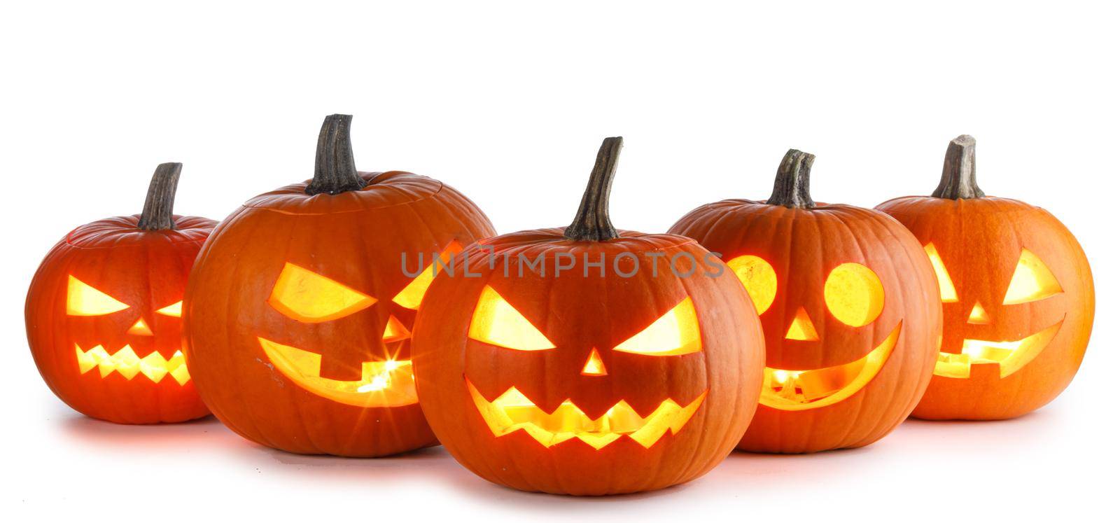 Five glowing Halloween Pumpkin lanterns isolated on white background