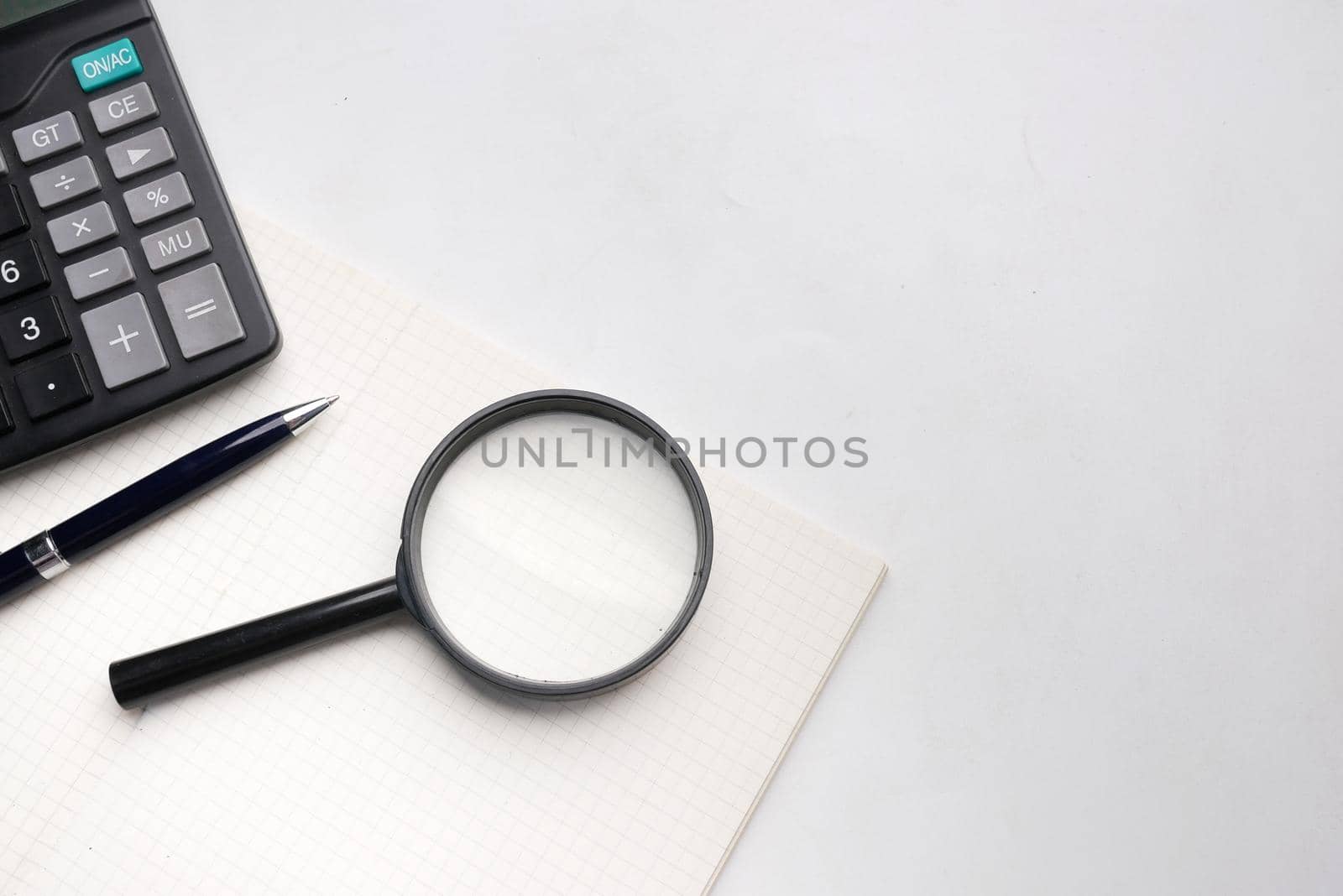 open book and magnifying glass on table