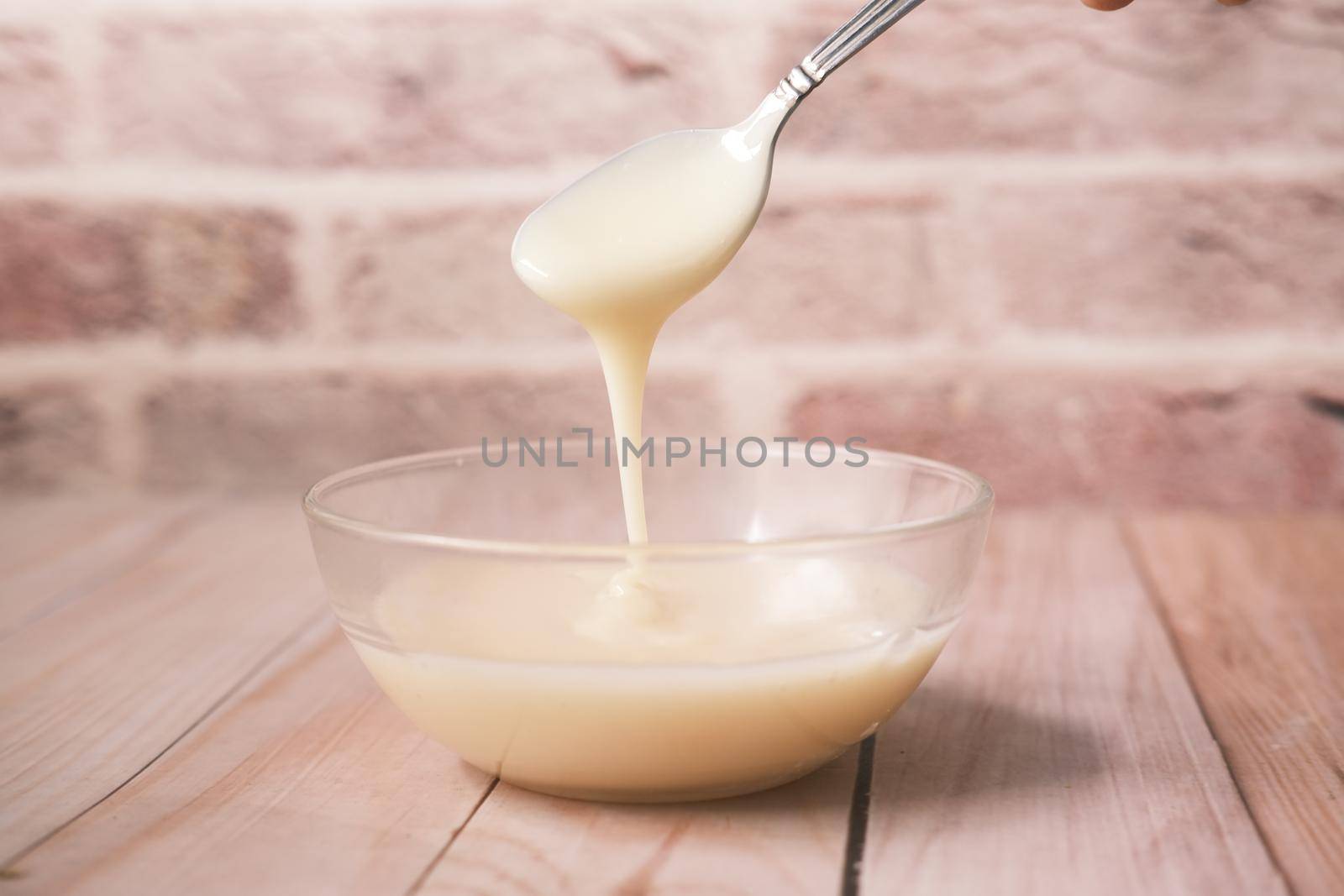 condensed milk in a bowl close up, by towfiq007
