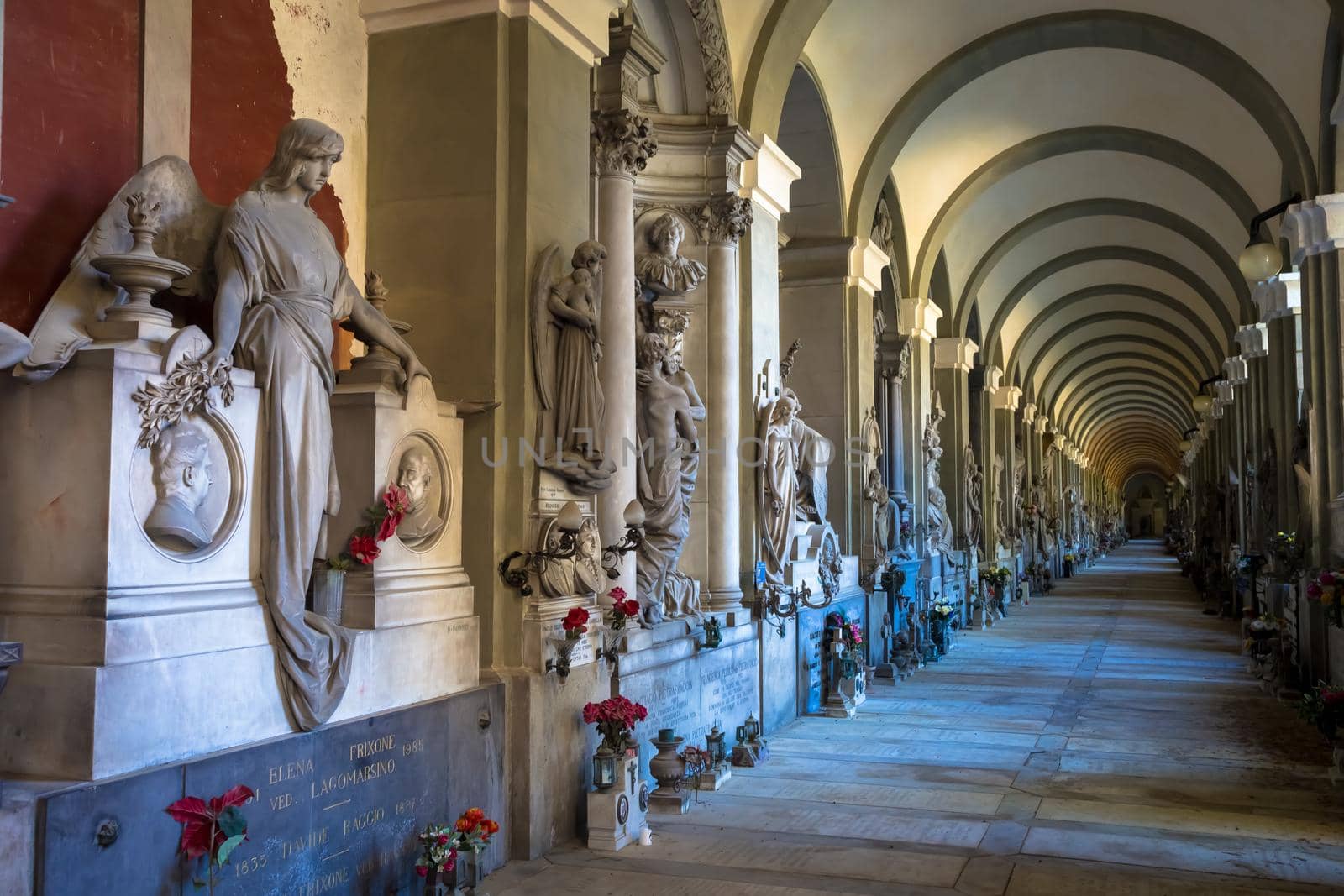 GENOA, ITALY - June 2020: corridor with statues - beginning 1800 - in a Christian Catholic cemetery - Italy