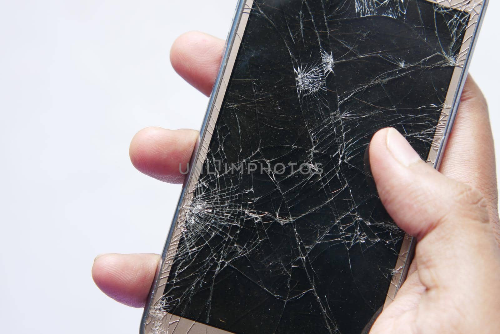 Close up of man hand holding broken smart phone