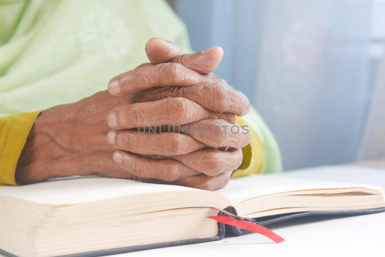senior women hand on a bibel by towfiq007