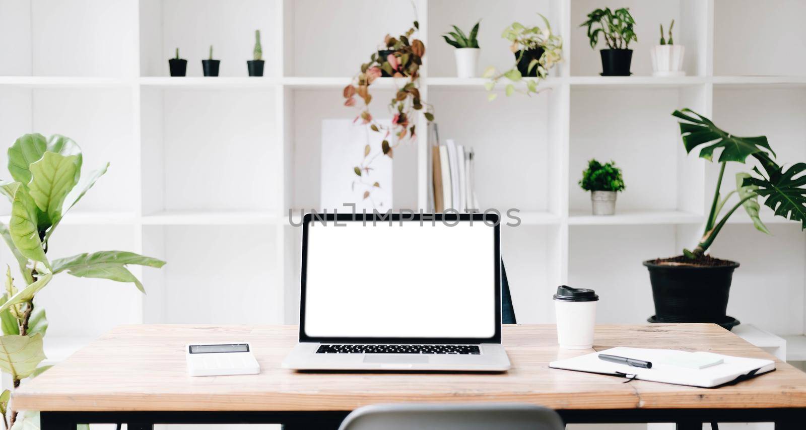 Workplace mockup concept. Mock up modern home decor desktop computer with vintage books, houseplant. Artist workspace with copy space for products display montage.Mockup desktop..