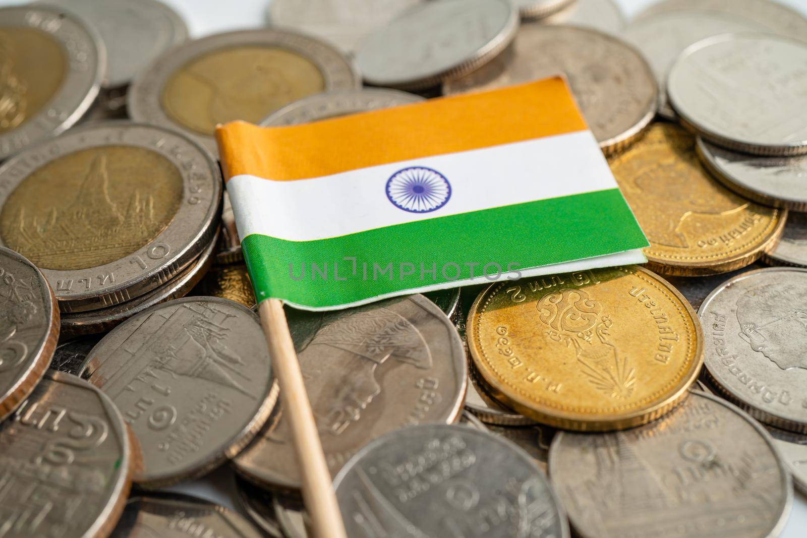 India flag on coins background, finance and accounting, banking concept.