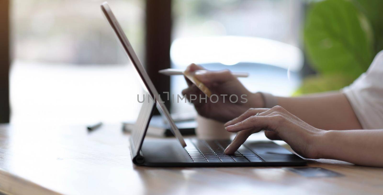 Woman using laptop with calculator and credit card on table, Online shopping.