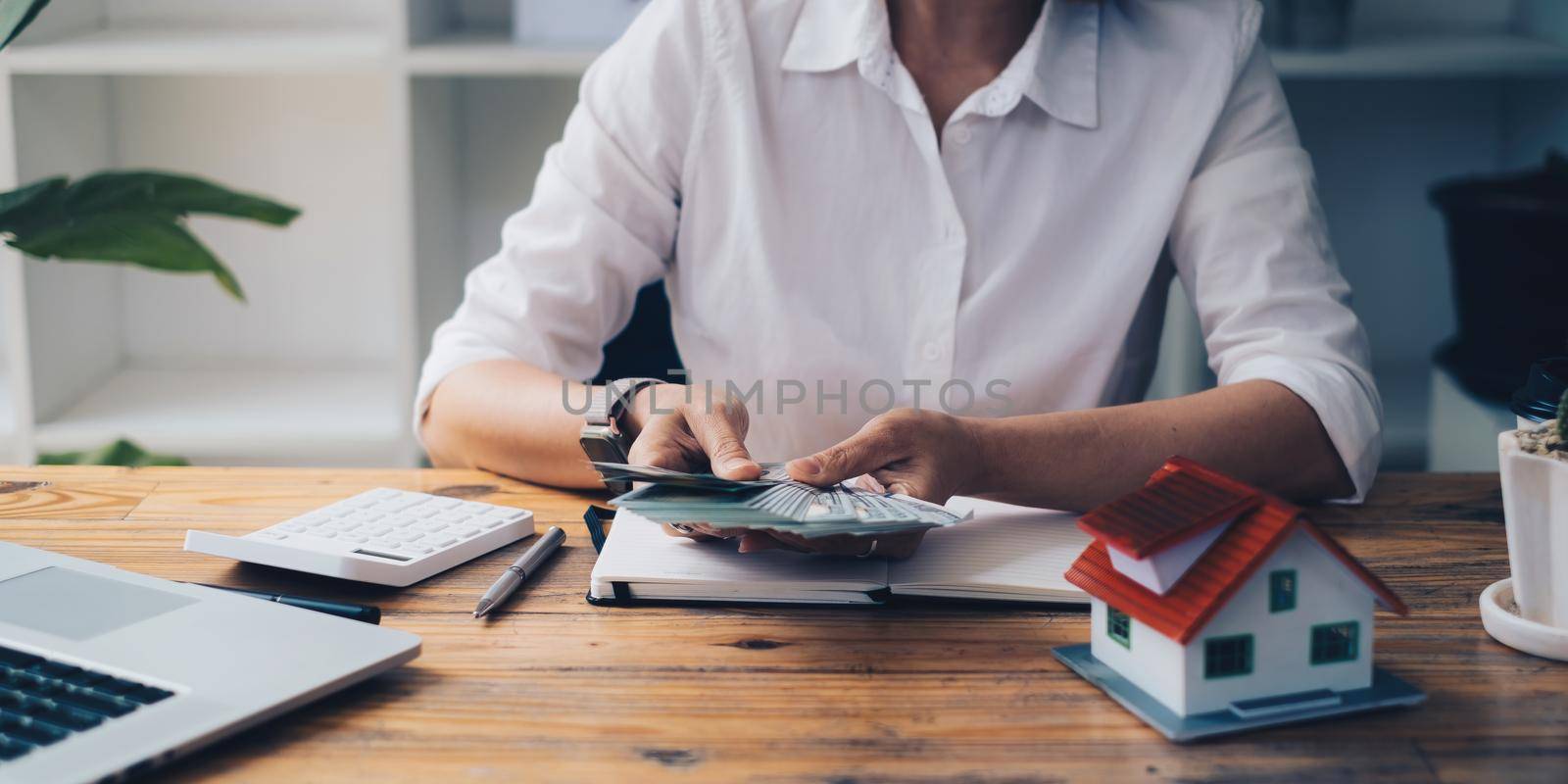 Business woman or broker checking money after contract agreement paper with customer to sign contract. Real Estate and Agreement concept. by itchaznong