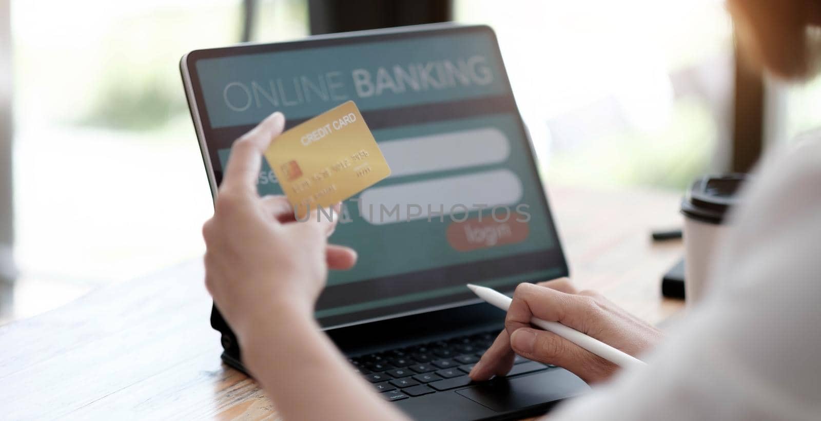 Online payment,woman's hands holding a credit card and using laptop computer for online shopping with vintage filter tone.