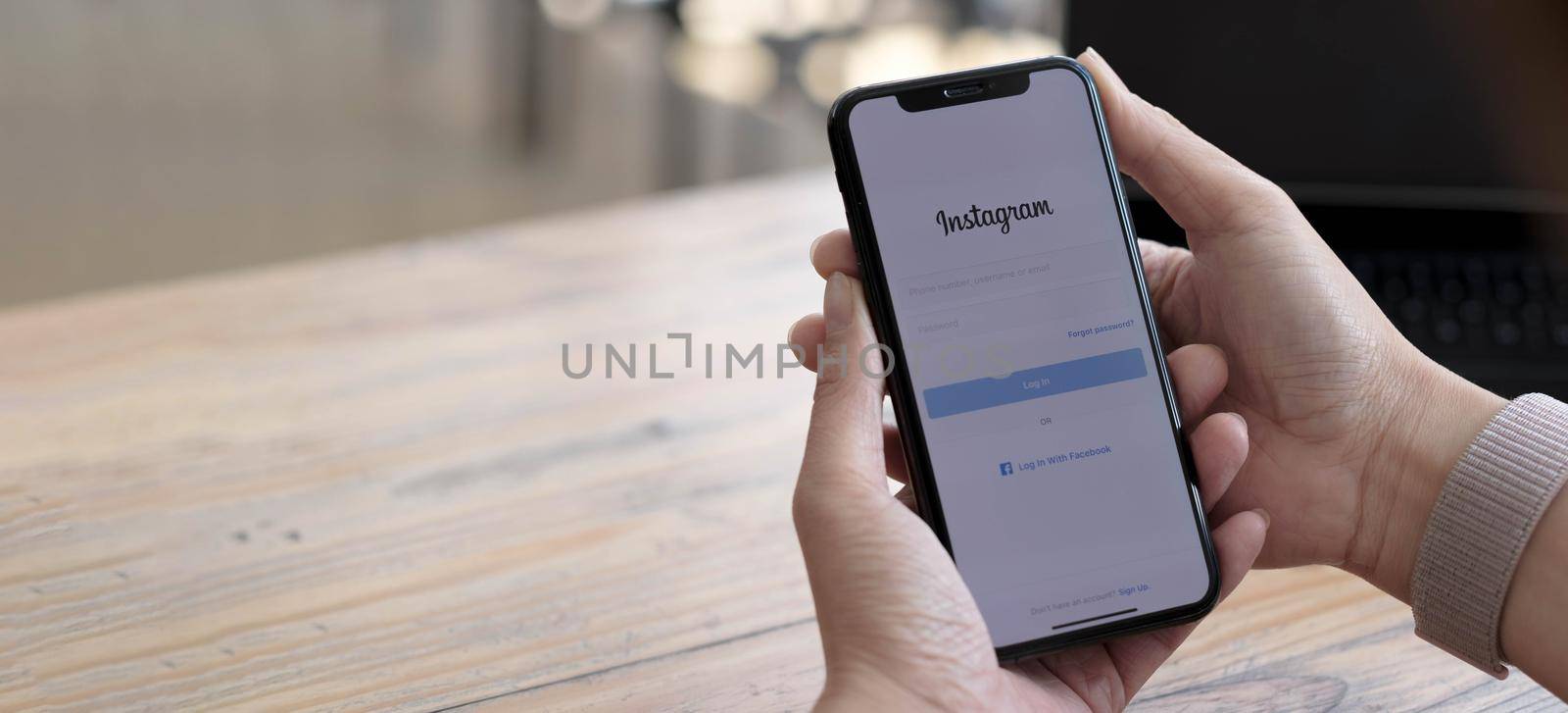 CHIANG MAI, THAILAND - SEP 24, 2021: A woman holds Apple iPhone X with Instagram application on the screen. Instagram is a photo-sharing app for smartphones..