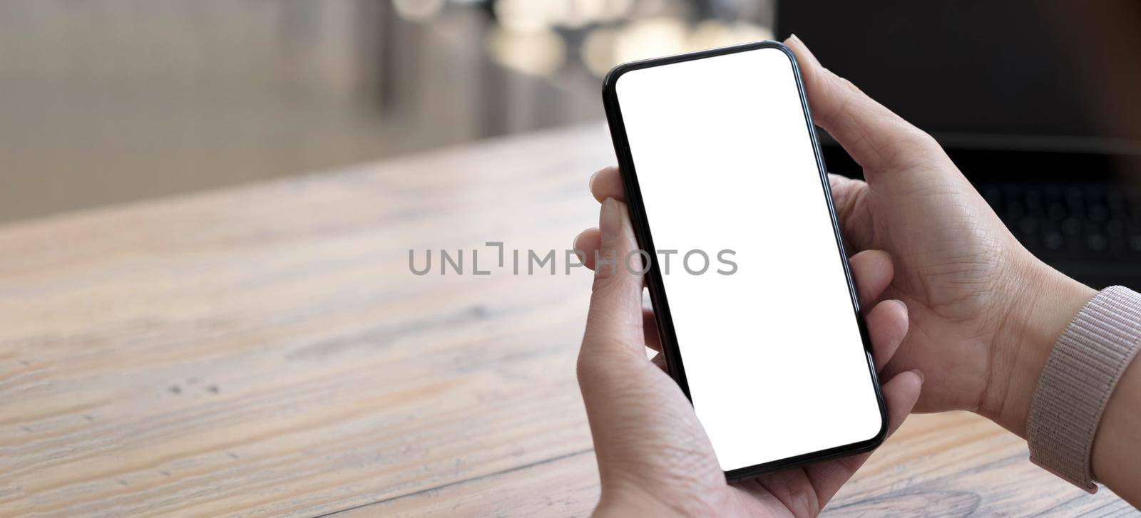 cell phone blank white screen mockup.woman hand holding texting using mobile on desk at office.background empty space for advertise.work people contact marketing business,technology by wichayada