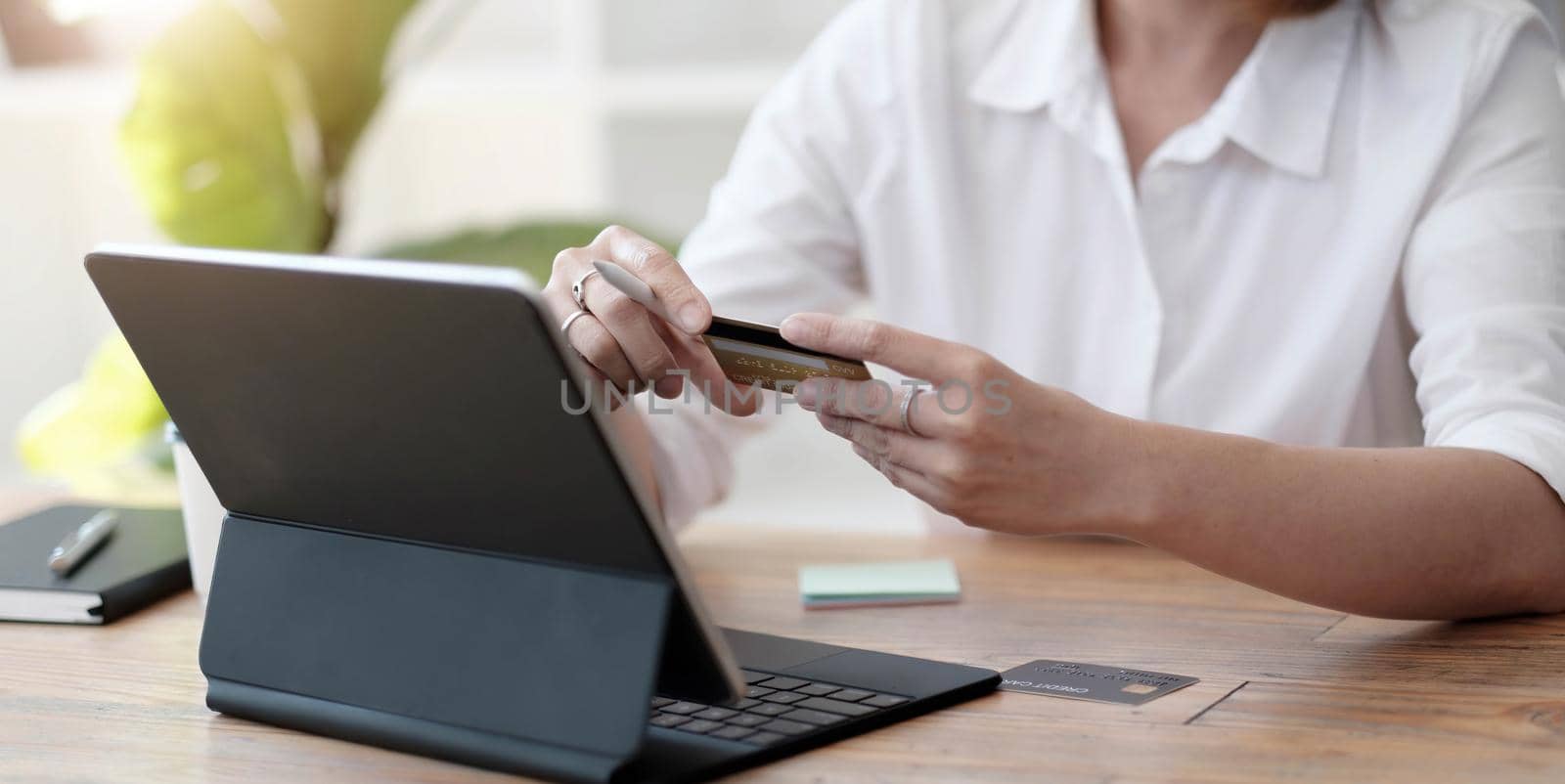 girl makes a purchase on the Internet on the computer with credit card.