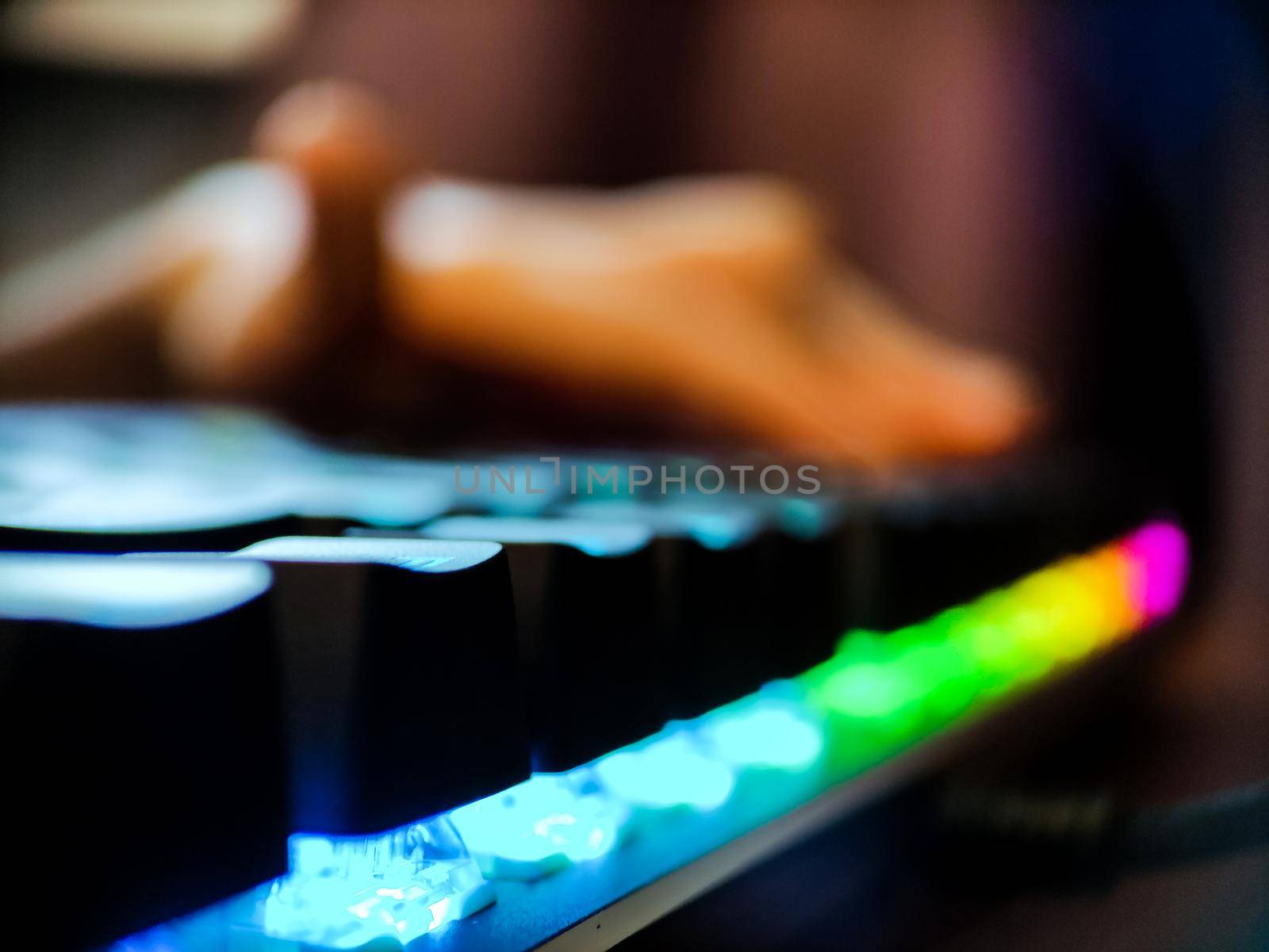 Gamer keyboard with neon backlight macro defocused close up. Online games and virtual reality concept background. High quality photo