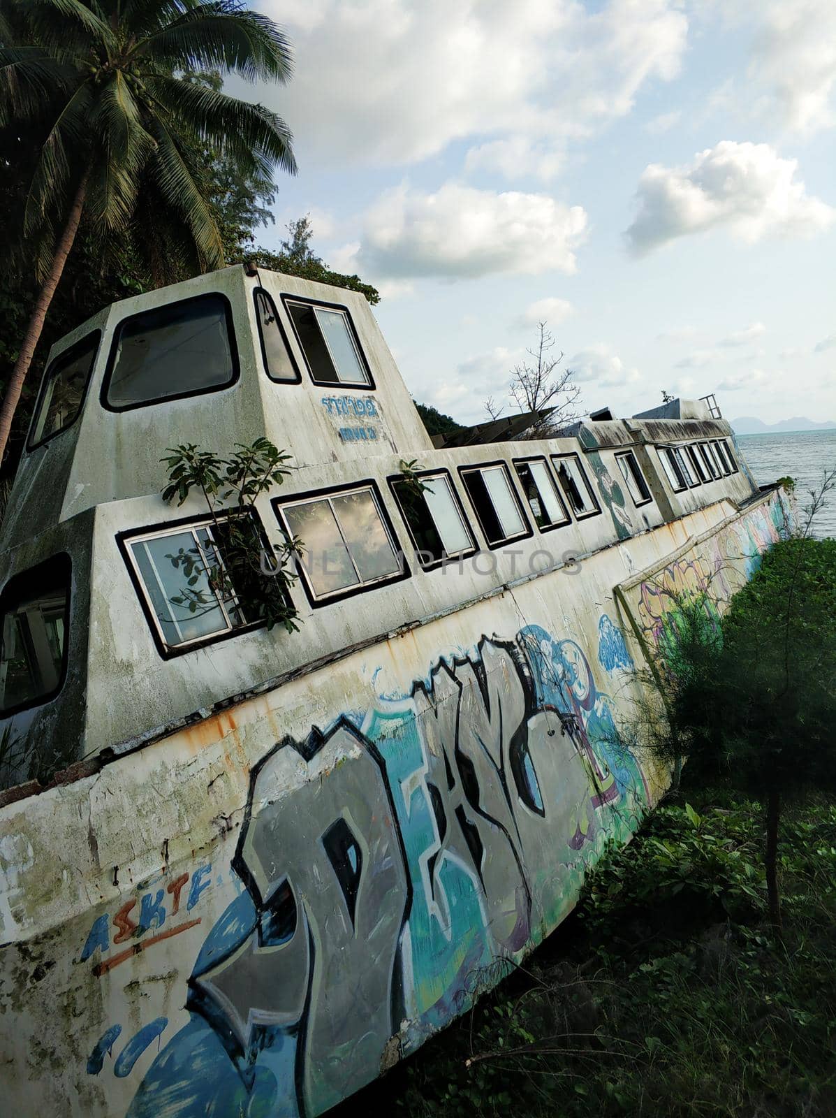 An abandoned ship rusts on the ocean shore. Samui , Tailand - 03.01.2020