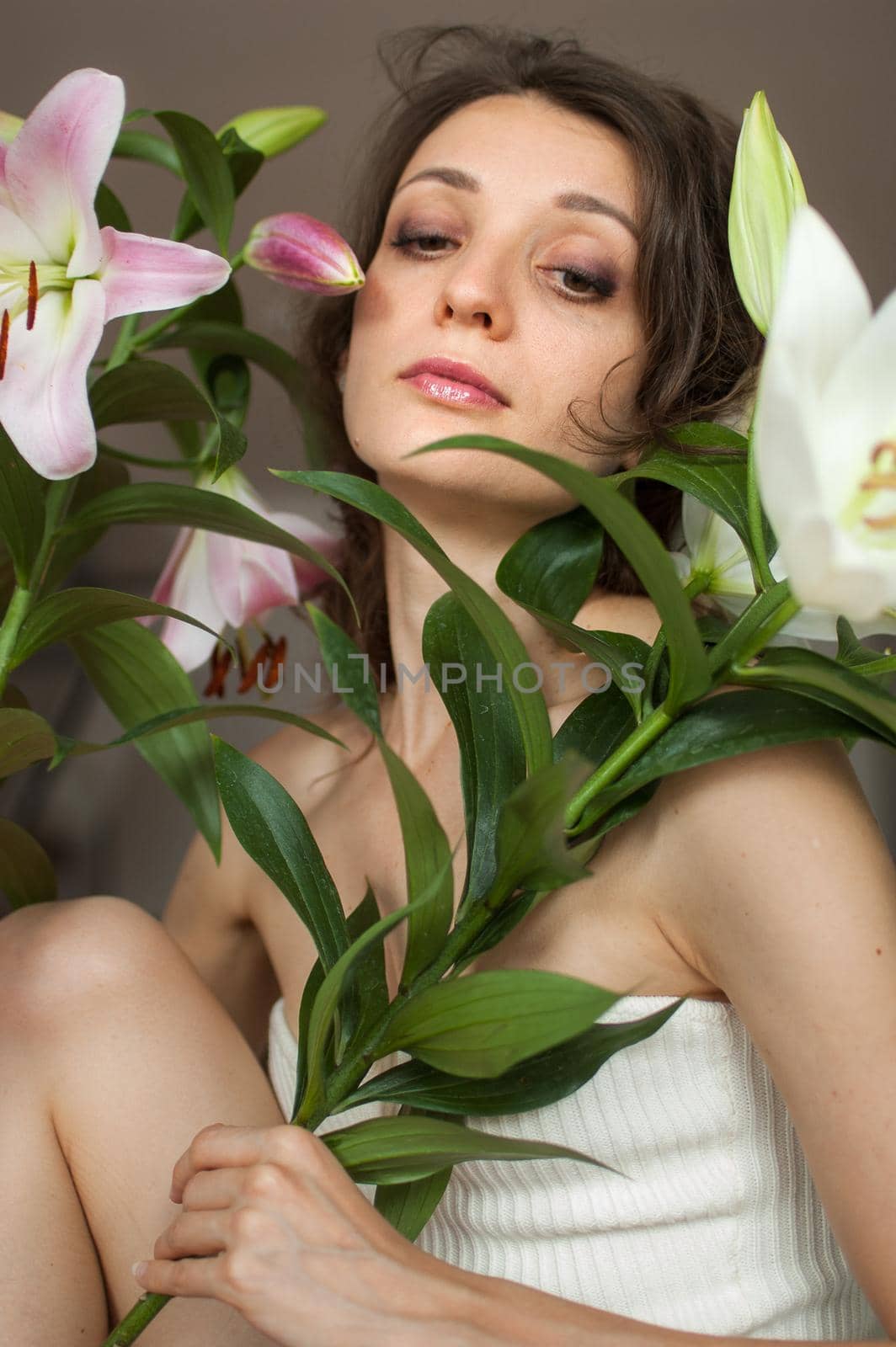 Fron view of beautiful woman with perfect bouquet of beautiful lilies, female portrait concept.