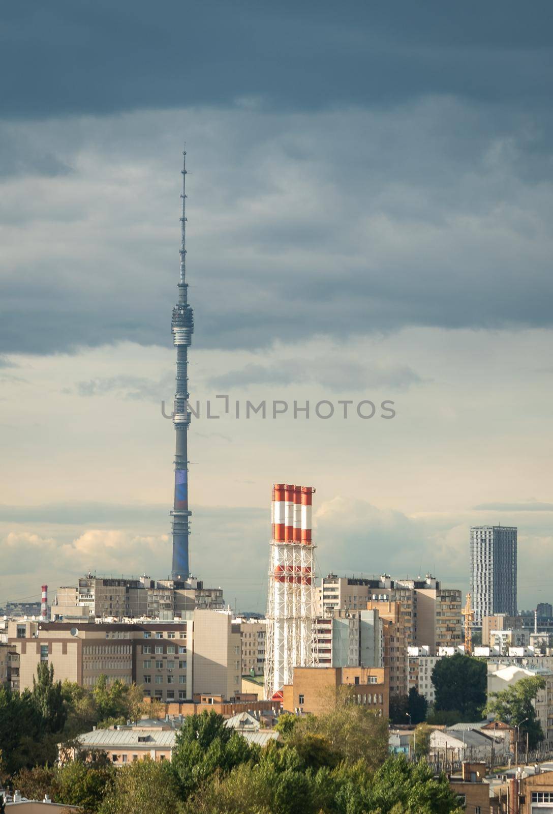 Ostankino Tower above Moscow cityscape in summer, Russia. Panorama of Moscow and TV tower on blue sky background. Moscow city skyline with Panoramic view of Moscow