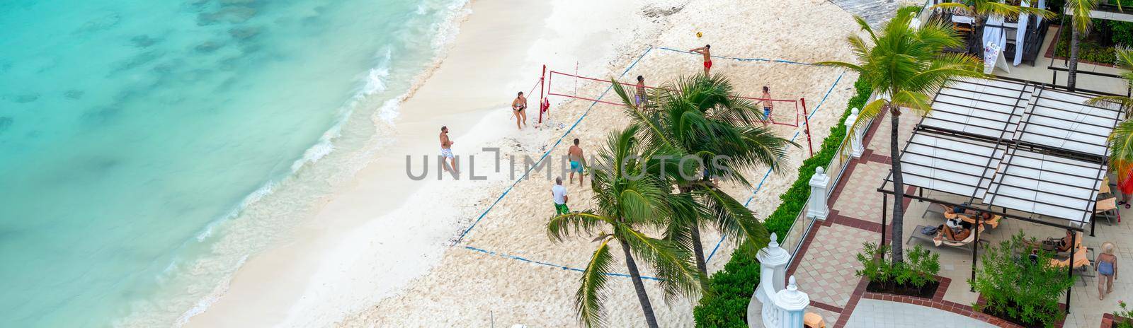 Tourists playing volleyball on a beach in all inclusive hotel in Cancun, Mexico.