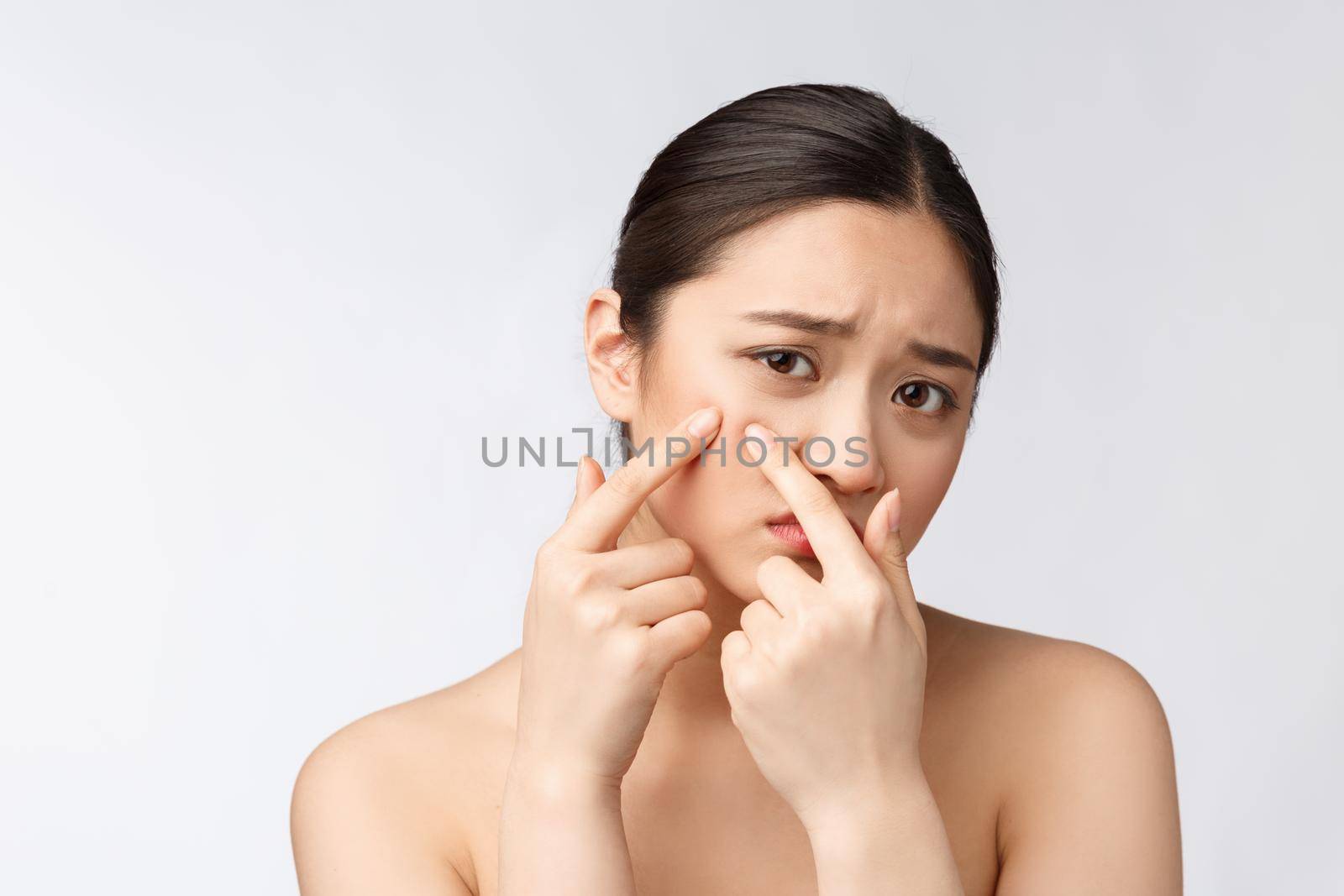 Face Skin Problem - young woman unhappy touch her skin isolated, concept for skin care, asian
