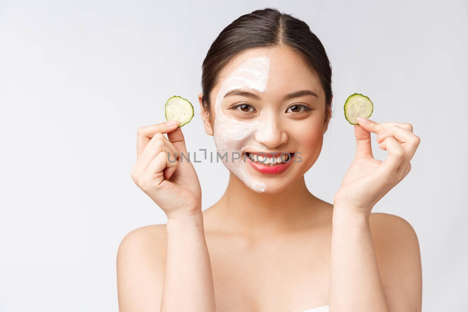 Beauty young asian women skin care image with cucumber on white background studio.