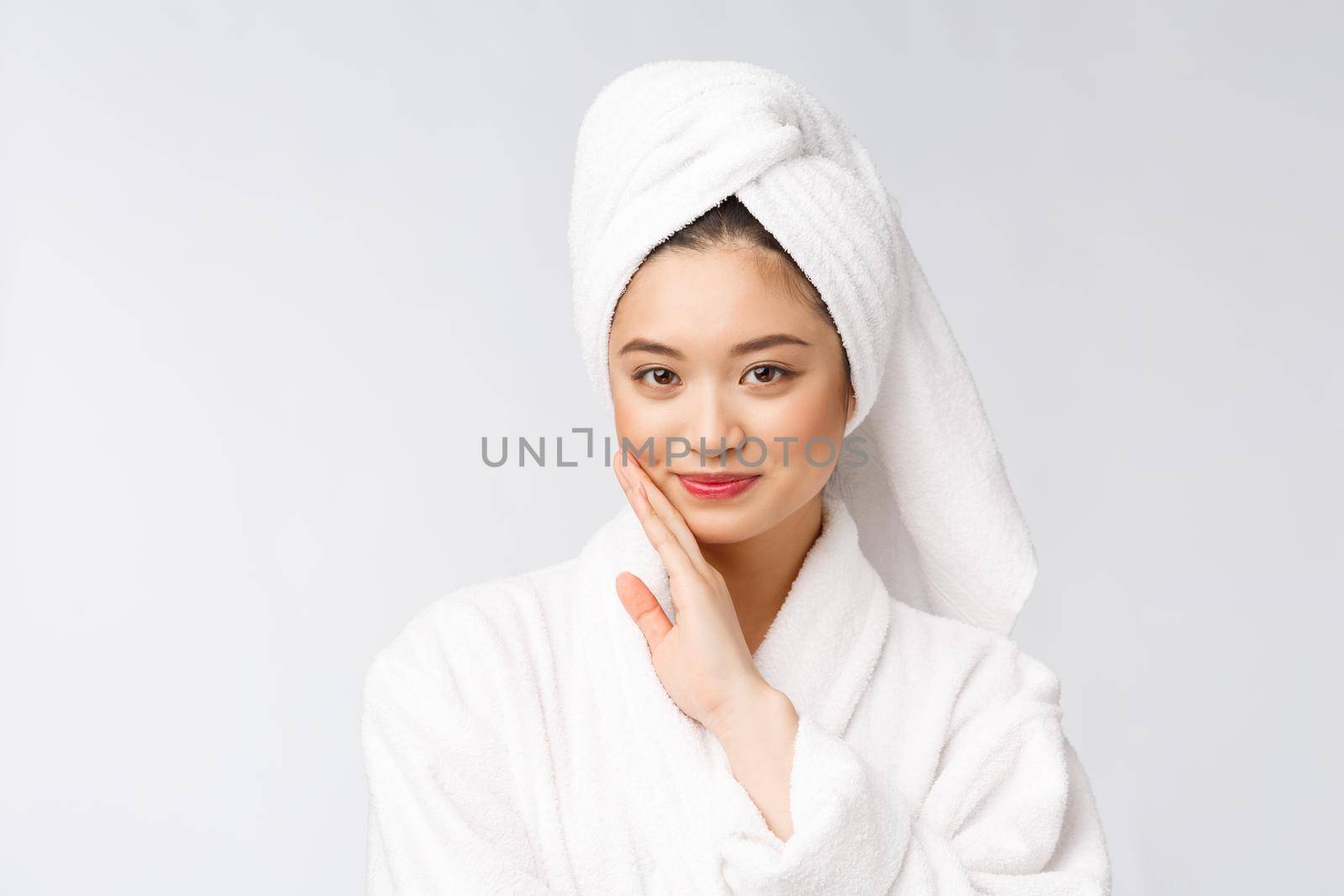 Spa skincare beauty Asian woman drying hair with towel on head after shower treatment. Beautiful multiracial young girl touching soft skin